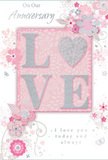 This anniversary card offers a gentle celebration of lasting romance, its design unfolding in soft pastel pinks and muted silvery greys that feel perfectly at home in a cosy Woodside living room. At the heart of the card, the word LOVE rises from the surface in soft, raised glitter, each letter delicately edged so that the light plays over it like sunlight on petals. The letter O is transformed into a shimmering silver heart, its textured surface inviting a slow, appreciative touch, echoing the feeling of holding onto the hand of someone dear. Surrounding this focal point, a cluster of delicate blooms in blush, mauve, and pale ivory seem to unfurl in a watercolor softness, their outlines fine and fluid, like flowers sketched by a florist planning an anniversary bouquet. Slender vines curl and weave between the blossoms, while tiny decorative flourishes-petals, swirling lines, and subtle, almost-transparent butterflies-add motion and a touch of whimsy, reminiscent of an English spring garden after a light rain, not far from the quiet streets of Woodside. The text On Our Anniversary and I love you today and always appears in graceful, understated script, positioned so that it feels naturally integrated with the floral motif rather than simply printed over it. The entire composition communicates a sense of cherished intimacy, like a soft-spoken promise renewed year after year. It is easy to imagine this card resting beside a vase of fresh flowers, a tender keepsake capturing the shared journey, calm and understated yet deeply heartfelt.
